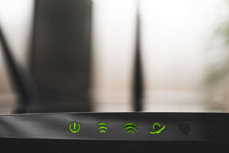Close up shot of internet router and green icons of WIFI connection.の写真素材