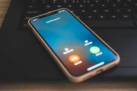 Incoming call from unknown number. Scam online on phoneの写真素材