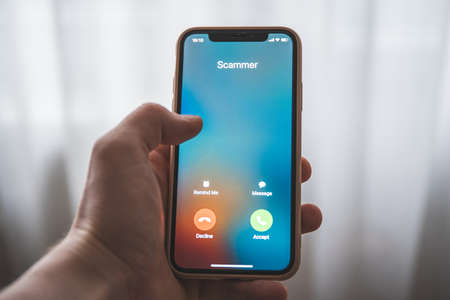 Incoming call from Scammer. Scam on phone and onlineの素材 [FY310165675307]