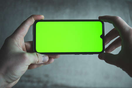 Smartphone with greenscreen.  Mobile phone frameless design concept template.の写真素材
