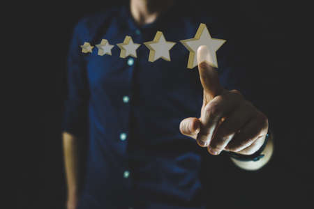 Man points on 5 star rating hologram. Five star rating on business, hotel, service. Quality guarantee ratingの写真素材
