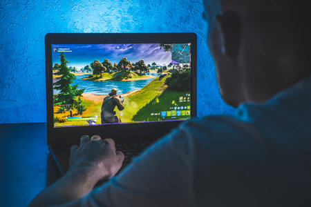 Person playing fortnite video game on computer