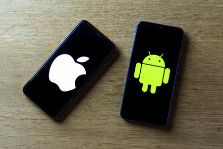 Apple and android smartphones. Iphone IOS versus Android operating systemのeditorial素材