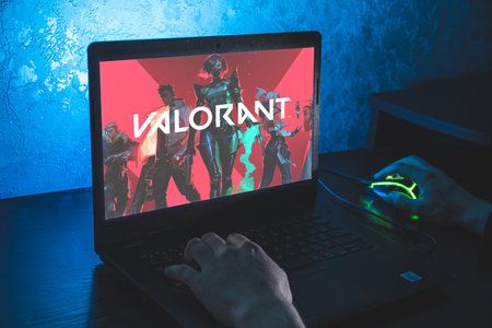Valorant is a free-to-play first-person hero online shooter. Video computer game. Man play video game on laptopのeditorial素材