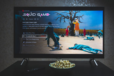 Watching Squid game show on TV. Squid game is a South Korean survival drama television series...