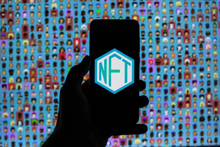 NTF logo on smartphone in  NTF's background. A non-fungible token is a unique and non-interchangeable unit of data stored on a digital ledgerのeditorial素材