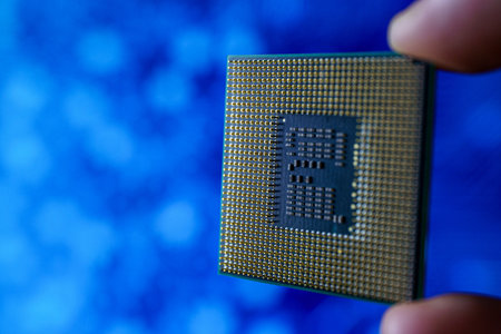 Computer chip in hands. A chipset is a set of electronic component that is integrated and flows data...