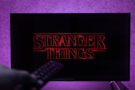 Watching Stranger Things television show on TV. Stranger Things is an American science fiction...