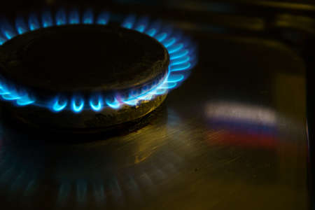 Gas at home for cooking. Natural gas (also called fossil gas) and Russian flag reflection. Nord Stream is a natural gas pipeline through the Baltic Sea from Russia to Europeの写真素材