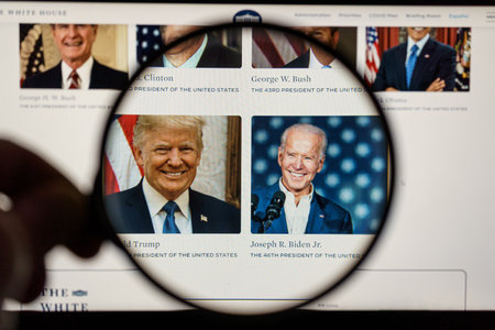 Joe Biden the president of United States of America and Donald Trump on the news. Looking through magnifying glassのeditorial素材