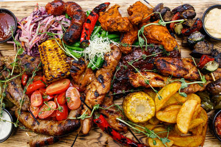 The mix of grilled meat and vegetables. Plate of mixed meat.の写真素材