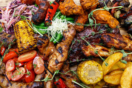 The mix of grilled meat and vegetables. Plate of mixed meat.の写真素材