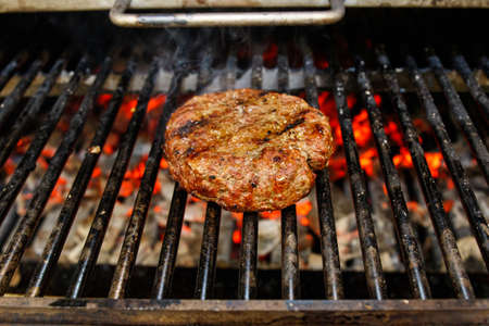 Beef burger for hamburger on barbecue flame grillの写真素材