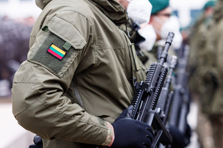 Lithuanian NATO soldier holding gun. The North Atlantic Treaty Organization, also called the North Atlantic Alliance, is an intergovernmental military alliance. Ukraine and Russia conflict.のeditorial素材