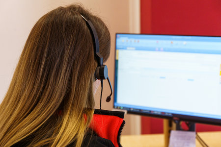 Call center Customer support. Woman talking with clients. Close up shot of headphonesの写真素材