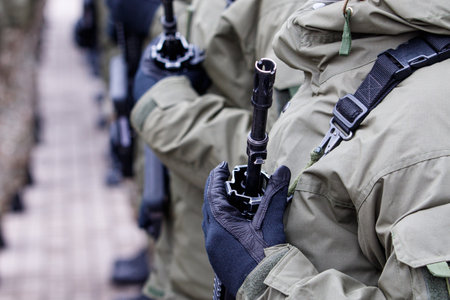 Lithuanian NATO soldier holding gun. Close up shot of soldier holding gun. Ukraine and Russia conflict.のeditorial素材