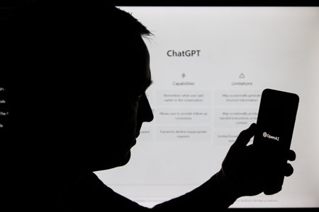 Man silhouette holding smartphone with ChatGPT . ChatGPT is AI chatbot which is made by OpenAIのeditorial素材