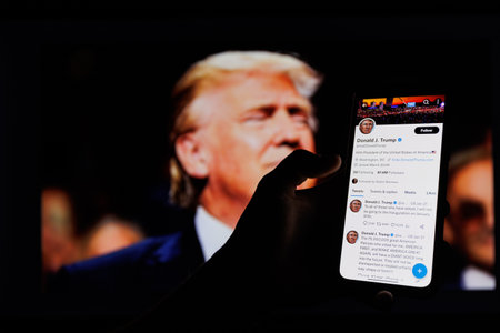 Donald Trump twitter account in front of Donald Trump on TVのeditorial素材