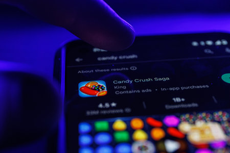 Paris, France - 2023 February 16: Candy crush saga app game on smartphone screen. Close up shot of candy crush gameのeditorial素材
