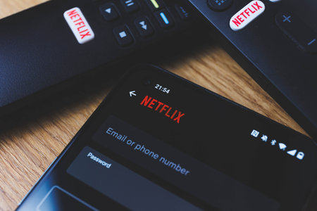 Netflix login on smartphone display. New password sharing rules on Netflixのeditorial素材