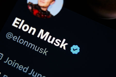 Close-up shot of Elon Musk twitter account. Blue verified icon checkmarkのeditorial素材