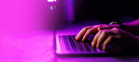 Close-up shot of Man typing on laptop with text free space on the side. Business, computer, coding,...