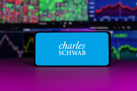 Charles Schwab stock market index in front of stock market charts backgroundのeditorial素材