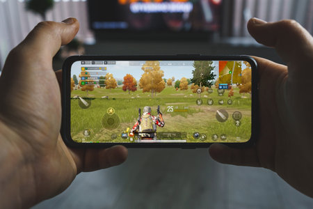 Playing PUBG mobile game. Point of view gaming on smartphoneのeditorial素材
