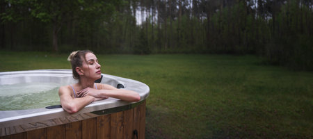 Young woman relax in hot tub SPA at the nature. Copy space image. High quality photoの写真素材