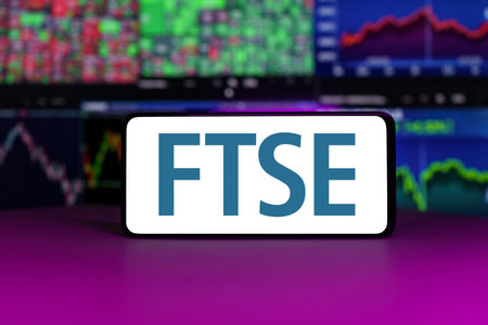 FTSE 100 stock market index in front of stock market charts backgroundのeditorial素材