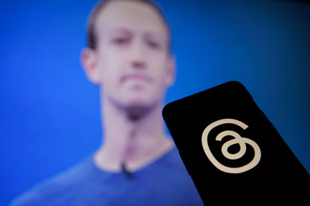 Threads an instagram app on phone screen and Mark Zuckerberg in the backgroundのeditorial素材