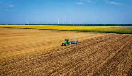 Varna, Bulgaria - Jul 09, 2020 Ploughing a field with John Deere 7730 tractor. John Deere was manufactured in 1995-1999 and it has JD 7.6L or 8.1L 6-cyl diesel engine.のeditorial素材