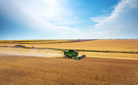 Dobrich, Bulgaria - July 07, 2020: Modern John Deere combine harvesting grain in the field near the town Dobrich, Bulgaria July 07, 2020のeditorial素材