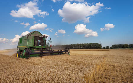Dobrich, Bulgaria - July 13: Modern John Deere combine harvesting grain in the field near the town Dobrich, Bulgaria July 13, 2017のeditorial素材