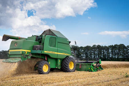 Dobrich, Bulgaria - Jul 8, 2016 Ploughing a field with John Deere. John Deere was manufactured in 1995-1999 and it has JD 7.6L or 8.1L 6-cyl diesel engine.のeditorial素材