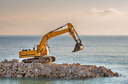 Hydraulic excavator parked in the construction area during the evening.