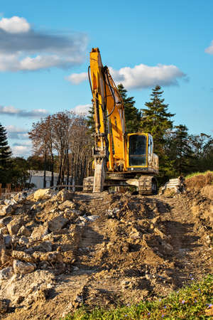 Hydraulic excavator parked in the construction area during the evening.