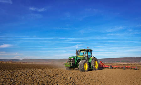Varna, Bulgaria - March 5, 2017 Ploughing a field with John Deere 6930 tractor. John Deere was manufactured in 1995-1999 and it has JD 7.6L or 8.1L 6-cyl diesel engine.のeditorial素材