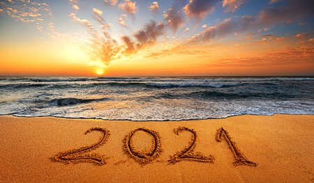 Happy New Year 2021! Written 2021 on the beach. Happy New Year 2021 is coming concept sandy.f