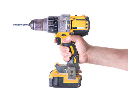 Yellow cordless battery powered drill isolated on white background.の写真素材