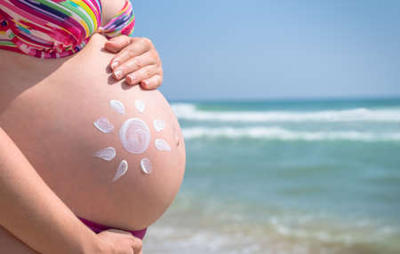 Pregnant woman skin care moisturizer cream.の写真素材