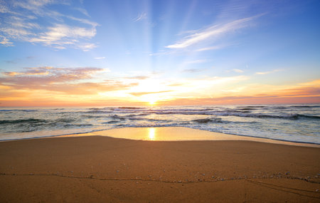 Beautiful sunset on the beach. Nature composition and vibrant colors.の写真素材