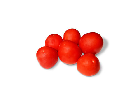 There are many tomatoes arranged in a store with white backgroundの写真素材
