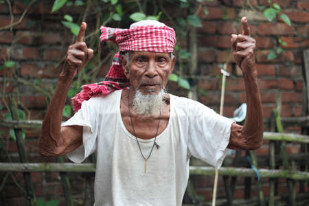 Bangladesh, Rangpur- July 03, 2021. An old man is standing with his arms outstretのeditorial素材
