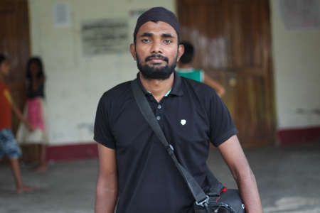 Bangladesh, Rangpur- July 03, 2021. A boy in a black T-shirt is standing with his arms outstretched and a big smile on his faceのeditorial素材