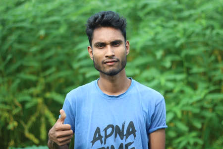 Bangladesh, Rangpur- July 03, 2021. A boys are standing with thumb finger out of one hand
