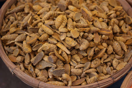 many dry Yellow roots row food in the market on the bamboo cageの写真素材