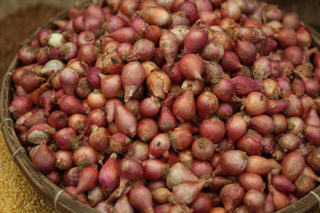 many onions in the  traditional bamboo cage on the marketの写真素材