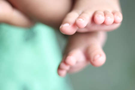 A baby has two legs and background too blur