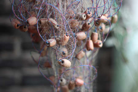 Fishing nets and Mesh sticks made of terracottaの写真素材